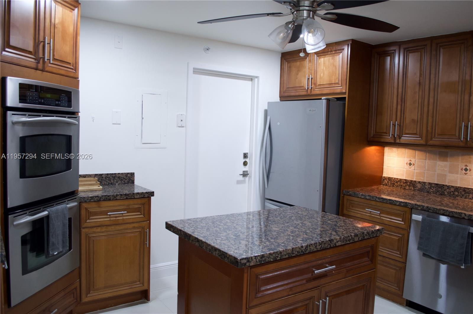 1370 South Ocean Boulevard, Unit 903 Pompano Beach, FL 33062 - Photo 10 of 30 a kitchen with stainless steel appliances granite countertop a refrigerator a stove a sink and dishwasher