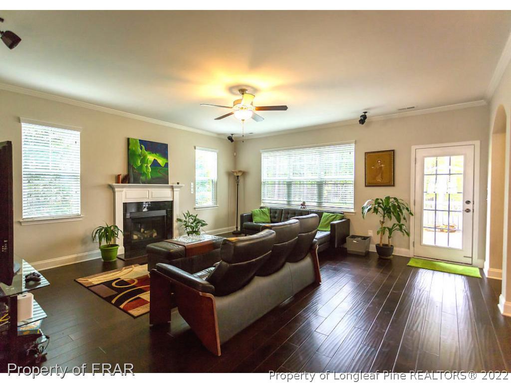 382 Falling Water Road Spring Lake, NC 28390 - Photo 6 of 36 a living room with fireplace furniture and a wooden floor