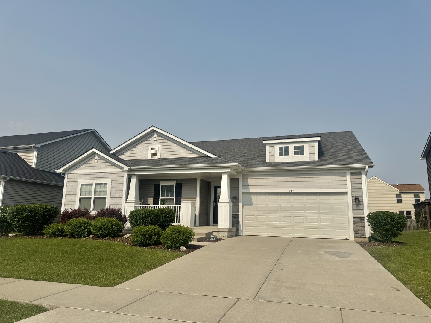 554 Stonebrook Drive Romeoville, IL 60446 - Photo 1 of 28 a front view of a house with a yard and garage