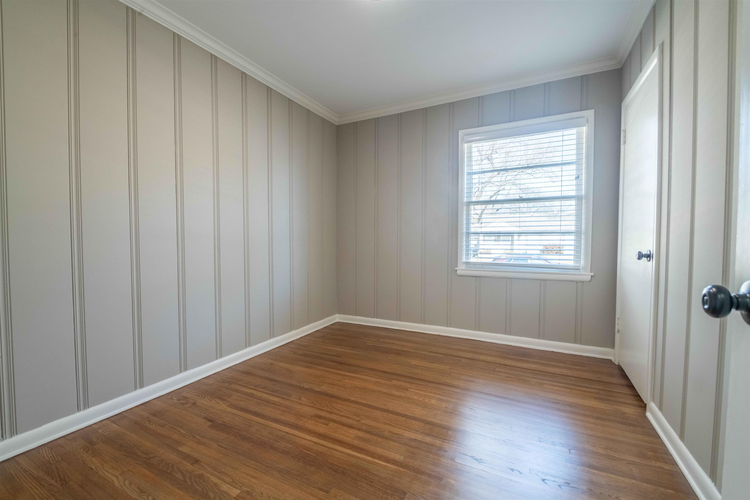 4915 Amboy Road Memphis, TN 38117 - Photo 11 of 17 a view of an empty room with wooden floor and a window