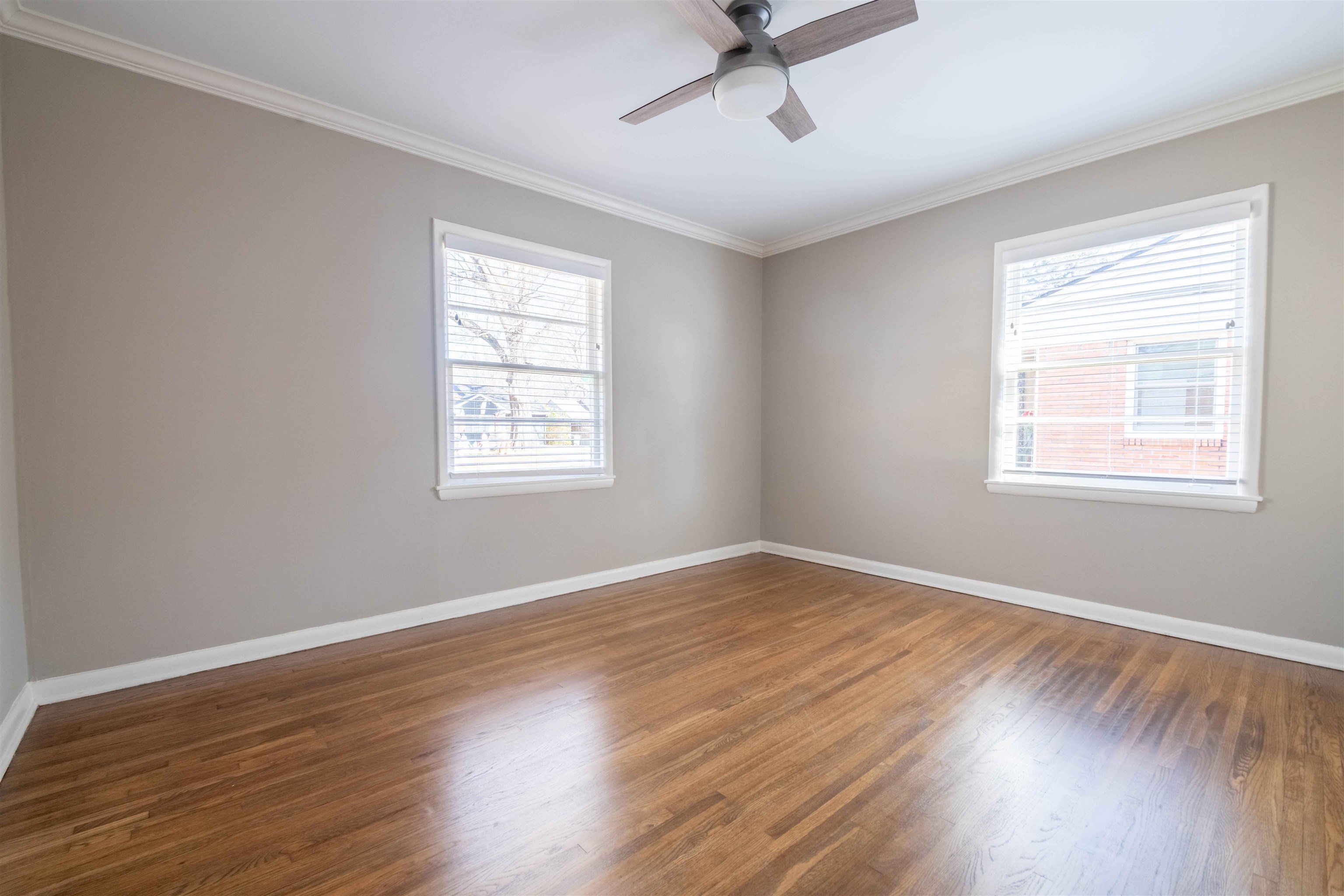 4915 Amboy Road Memphis, TN 38117 - Photo 14 of 17 a view of an empty room with wooden floor and a window