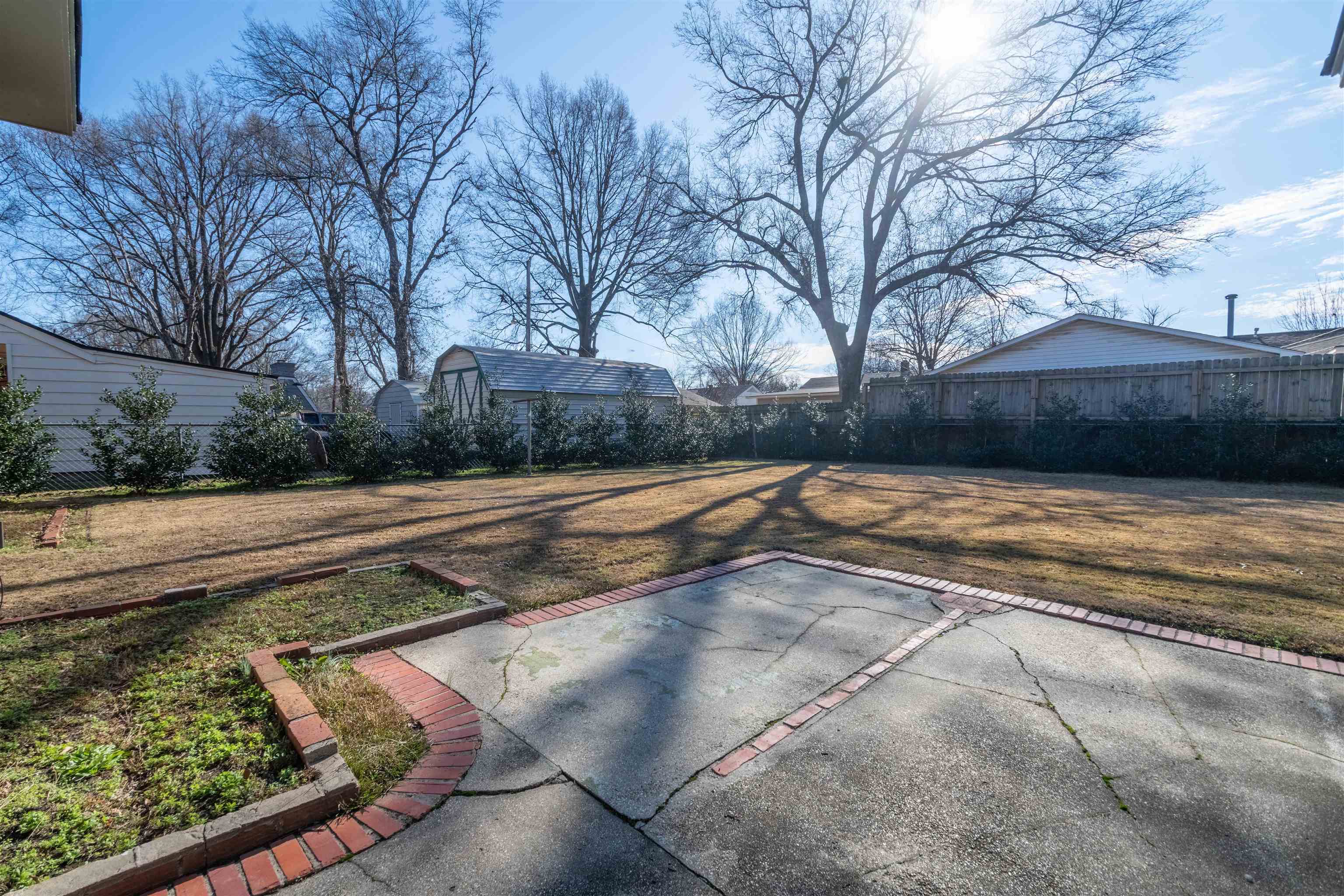4915 Amboy Road Memphis, TN 38117 - Photo 3 of 17 a view of yard with large trees and wooden fence