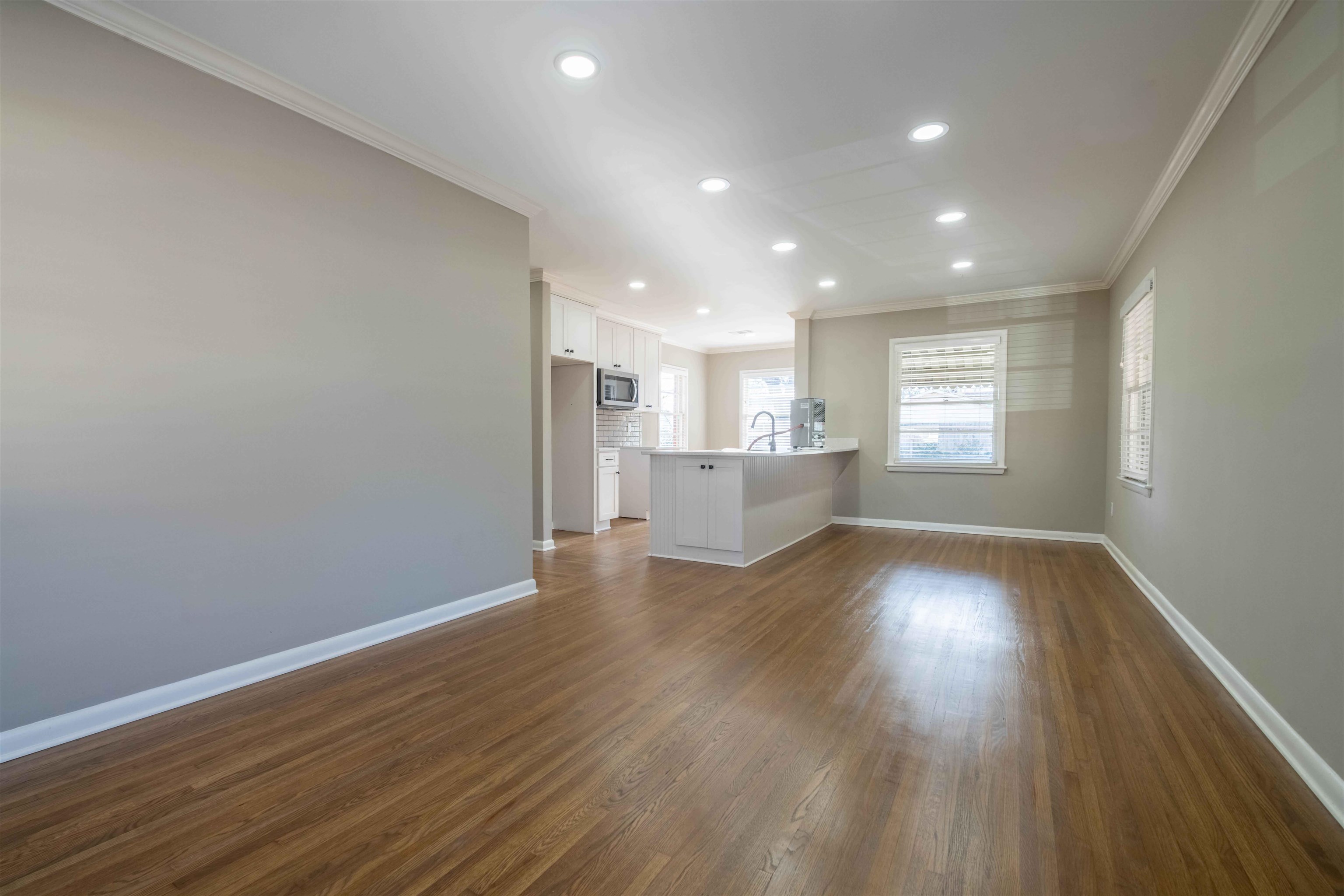 4915 Amboy Road Memphis, TN 38117 - Photo 6 of 17 a view of an empty room with wooden floor and a window