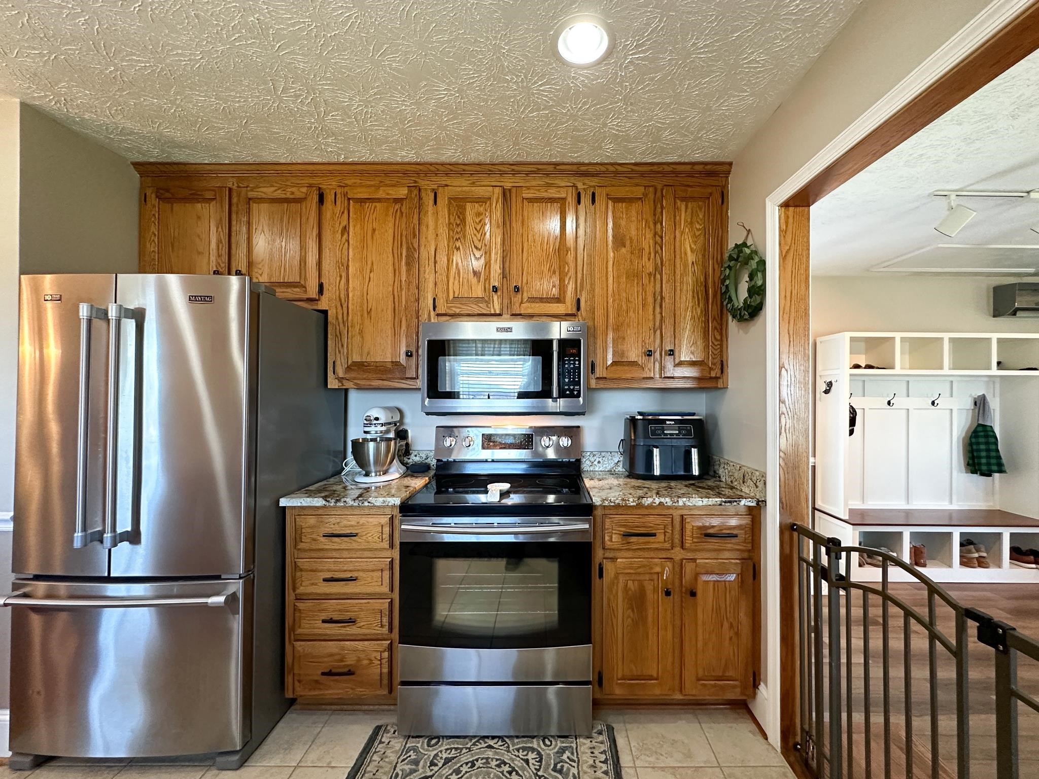 164 Spring Meadows Staunton, VA 24401 - Photo 21 of 37 a kitchen with stainless steel appliances granite countertop a refrigerator stove and sink