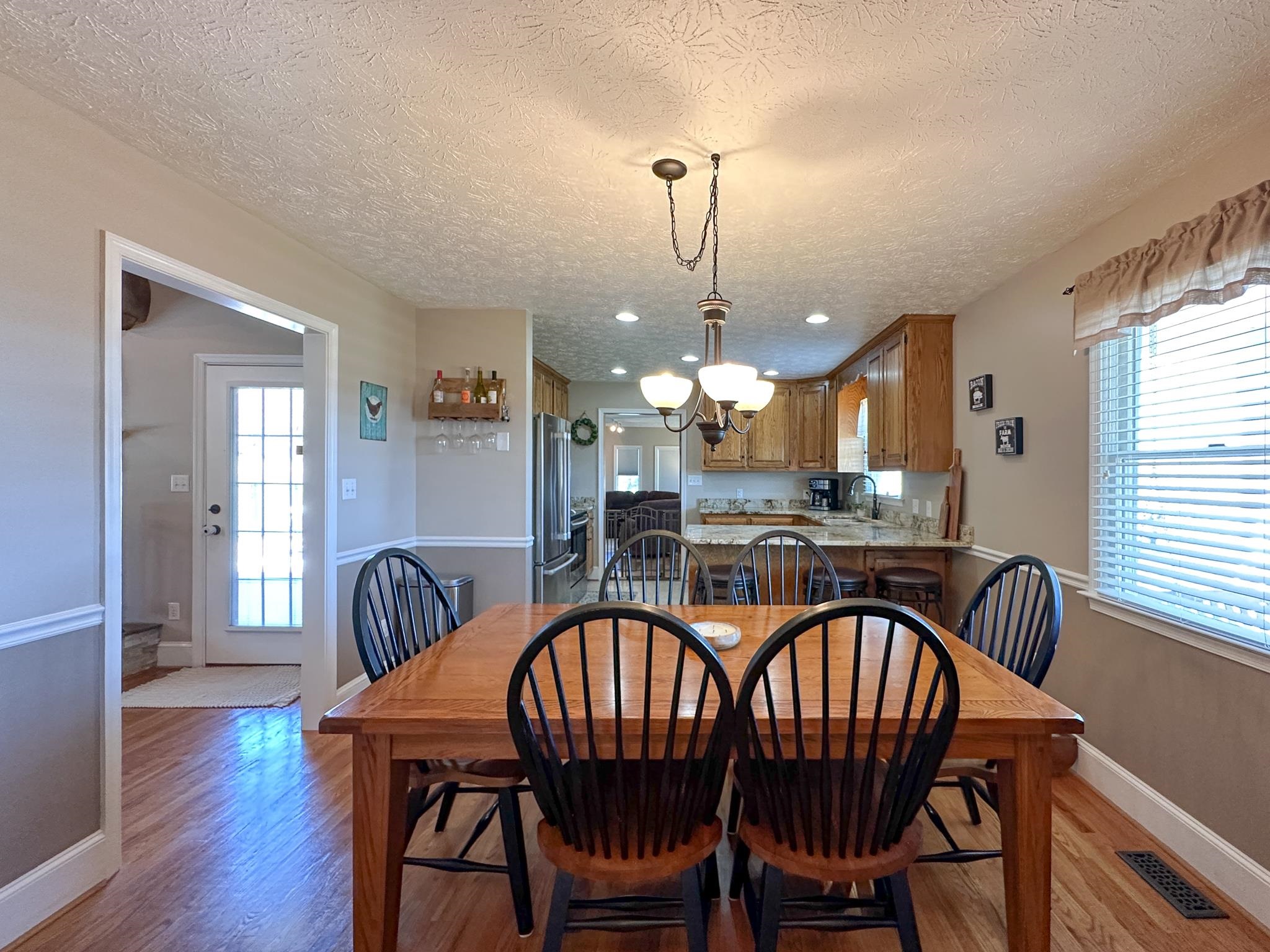 164 Spring Meadows Staunton, VA 24401 - Photo 23 of 37 a view of a dining room and livingroom with furniture wooden floor a chandelier