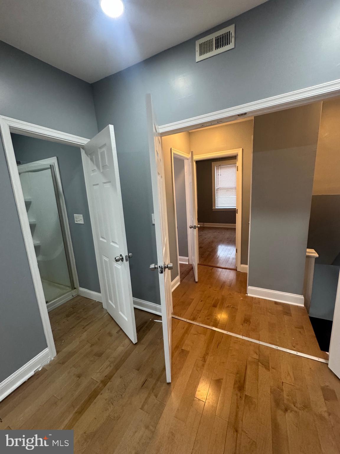 3221 Lyndale Avenue Baltimore, MD 21213 - Photo 14 of 21 a view of a room with wooden floor and windows