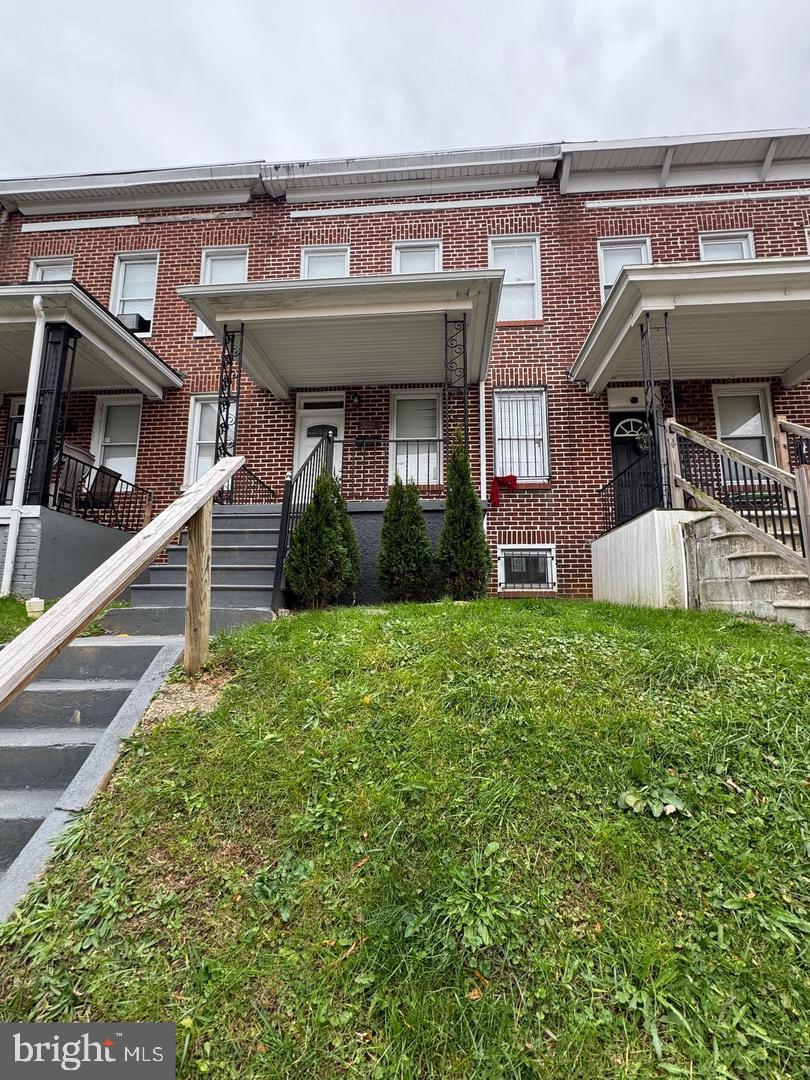 3221 Lyndale Avenue Baltimore, MD 21213 - Photo 3 of 21 a front view of a house with garden