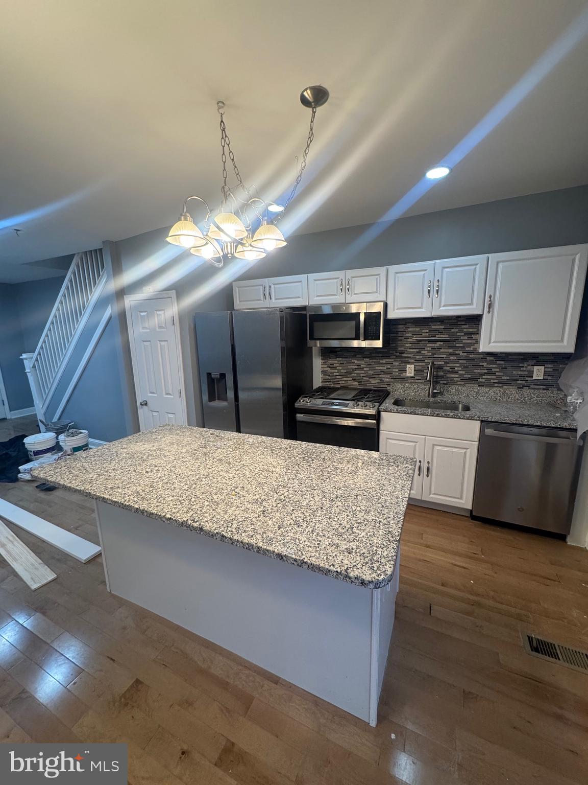 3221 Lyndale Avenue Baltimore, MD 21213 - Photo 4 of 21 a kitchen with stainless steel appliances granite countertop a sink a stove counter space and cabinets