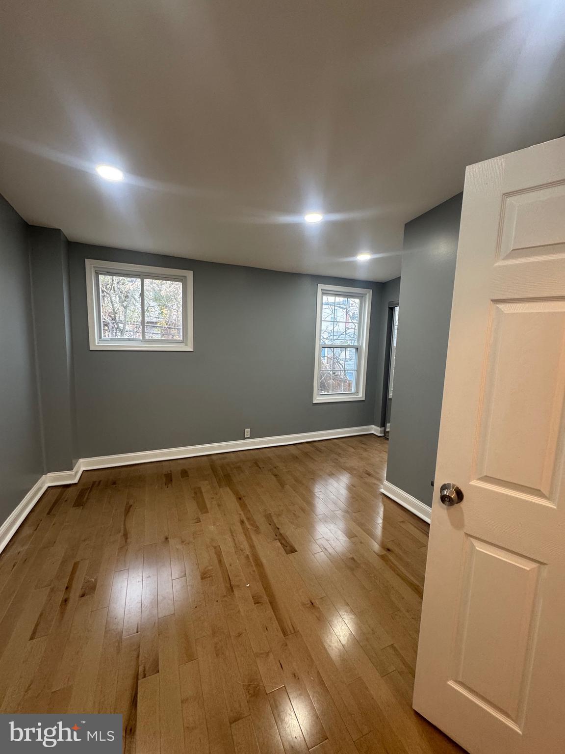 3221 Lyndale Avenue Baltimore, MD 21213 - Photo 6 of 21 an empty room with wooden floor and window