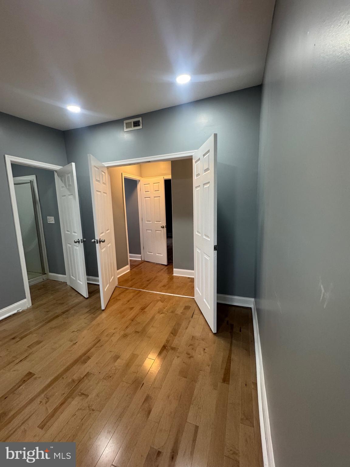 3221 Lyndale Avenue Baltimore, MD 21213 - Photo 9 of 21 an empty room with wooden floor and a window