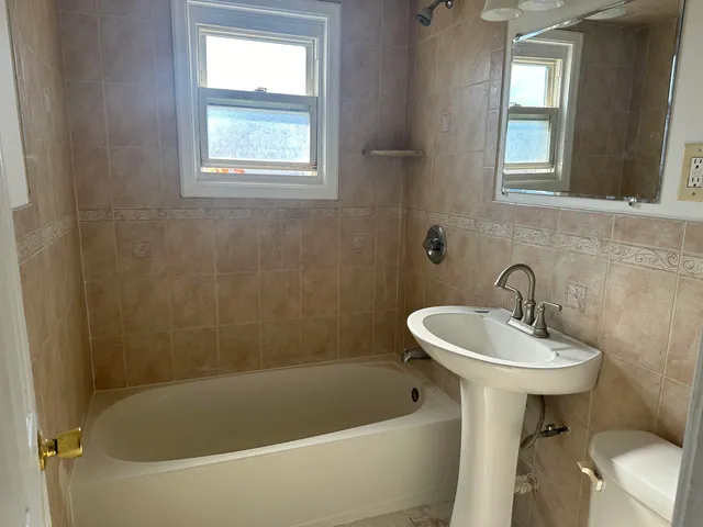 a white bath tub sitting next to a white sink