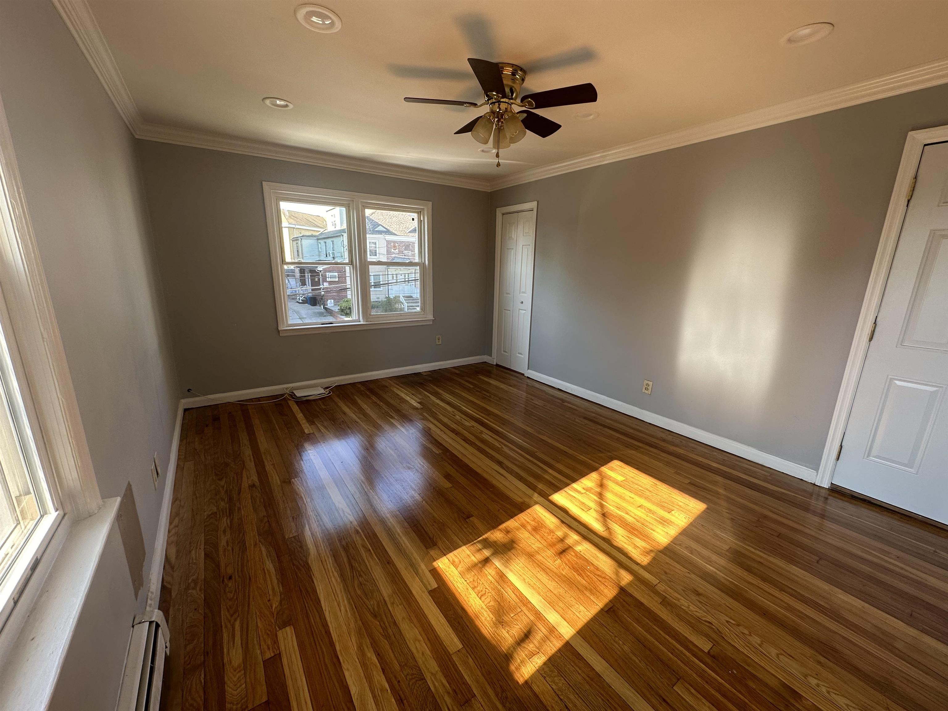 6 Kelly Parkway, Unit 2 Bayonne, NJ 07002 - Photo 5 of 9 a view of empty room with wooden floor and fan