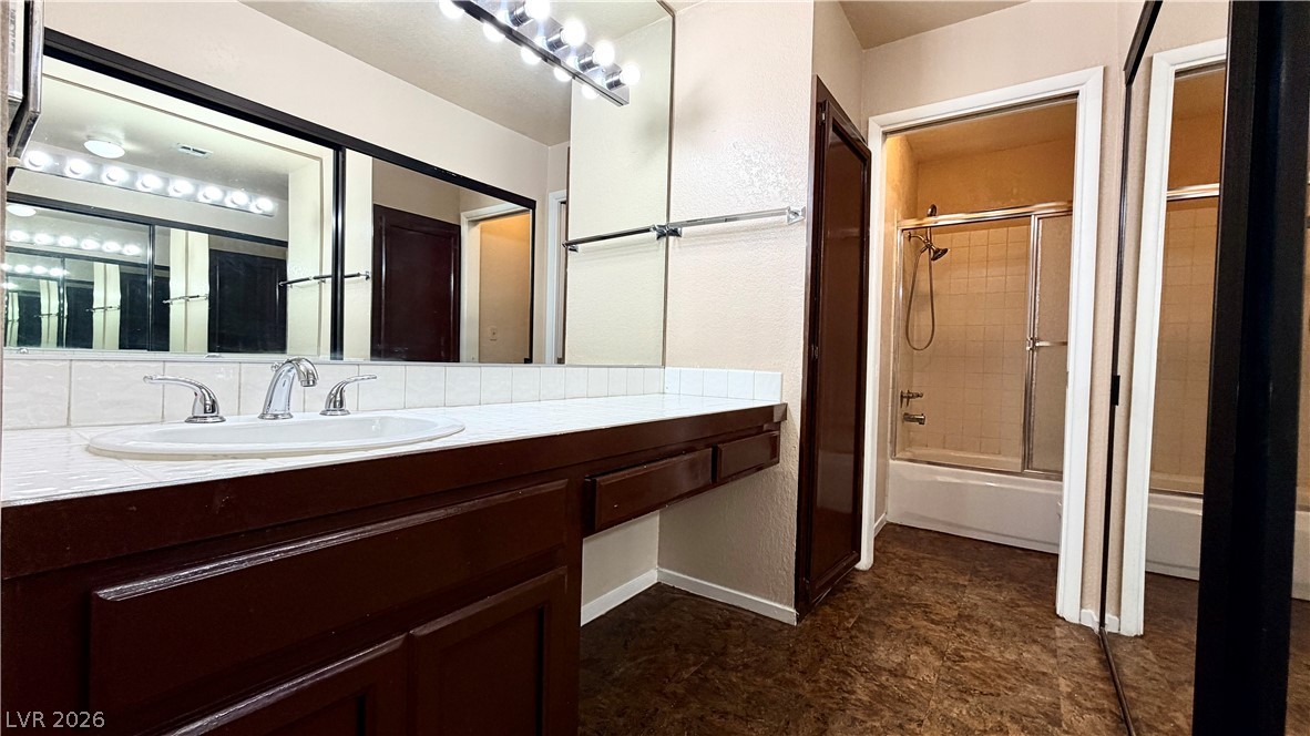 6250 West Flamingo Road, Unit 4 Las Vegas, NV 89103 - Photo 21 of 45 This functional bathroom features a shower-tub combo and a large vanity with ample counter space.