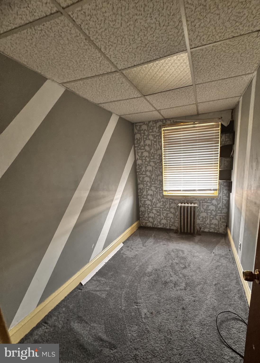 7033 Radbourne Road Upper Darby, PA 19082 - Photo 7 of 9 a view of a livingroom with an empty space and a window