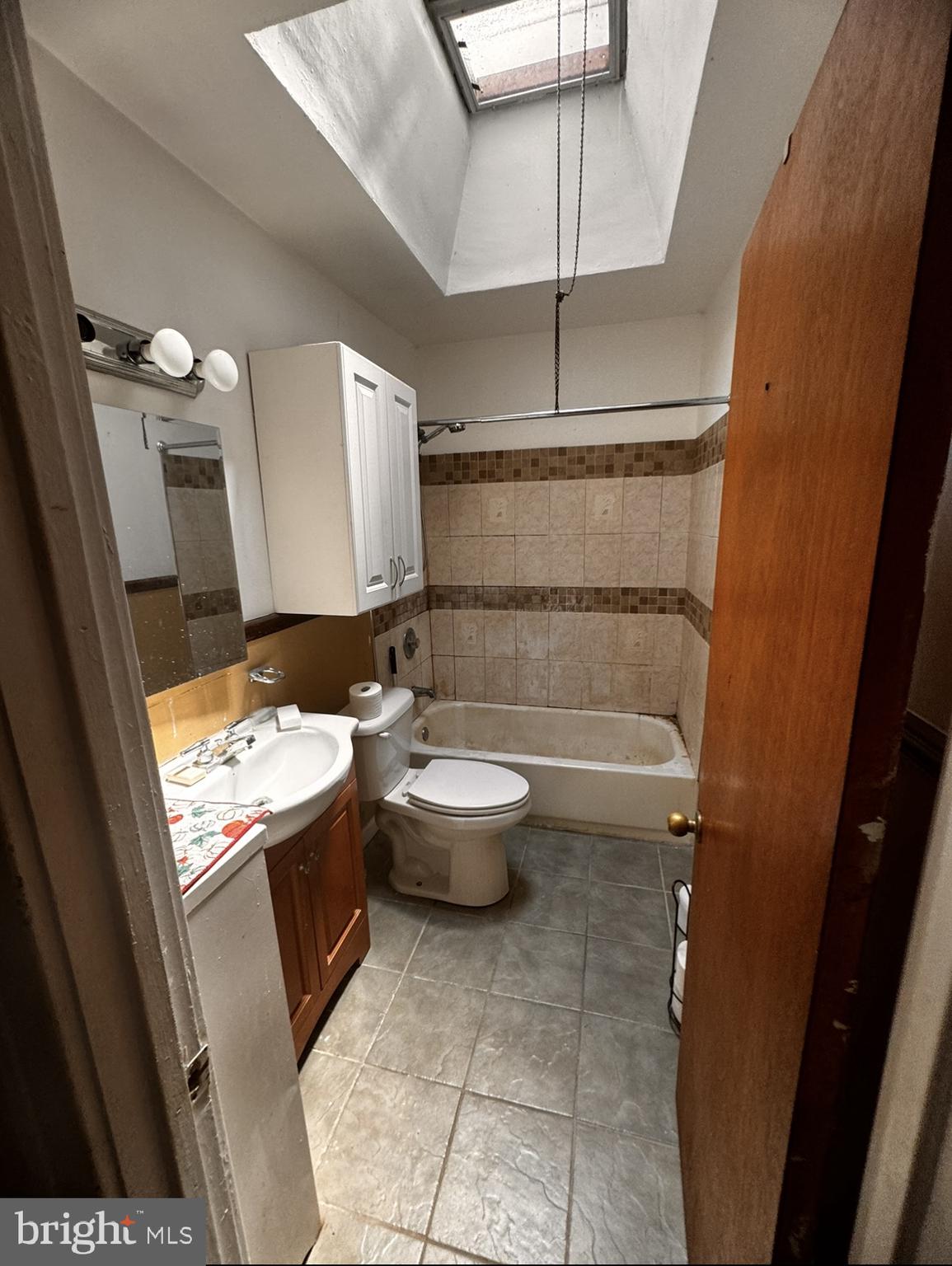 7033 Radbourne Road Upper Darby, PA 19082 - Photo 8 of 9 a bathroom with a granite countertop sink toilet and shower