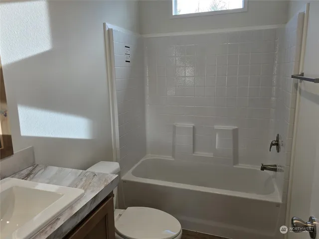 a large kitchen with stainless steel appliances granite countertop a stove refrigerator and a sink