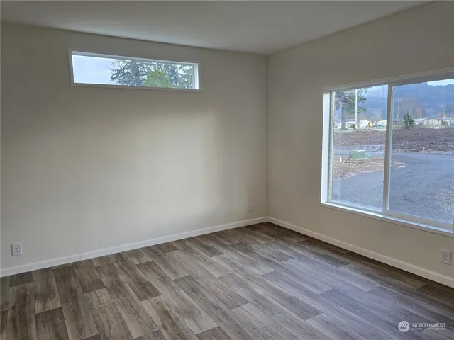 a bathroom with a granite countertop toilet a sink and a mirror