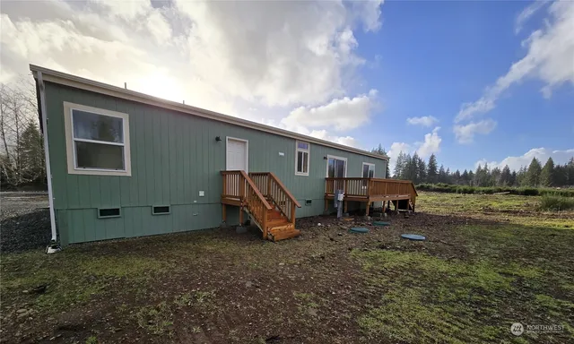 a view of a house with a yard and sitting area