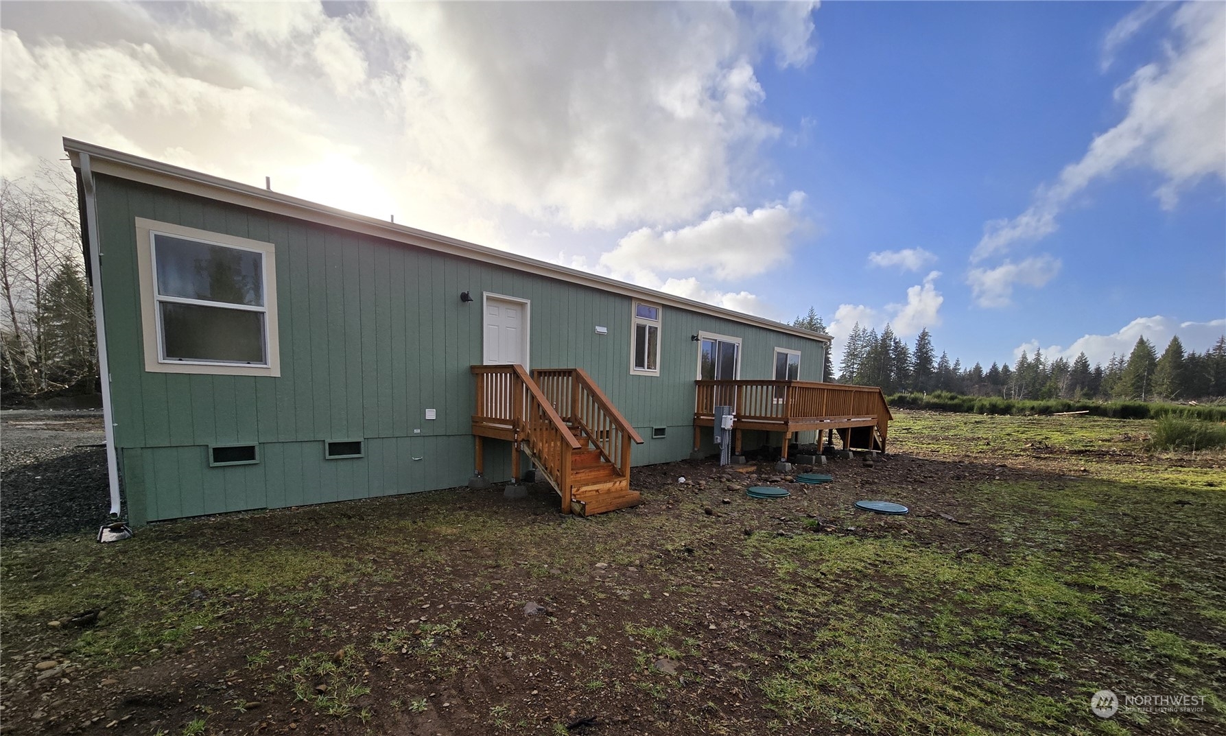 53 Newton Rd Forks Forks, WA 98331 - Photo 20 of 25 a backyard of a house with table and chairs