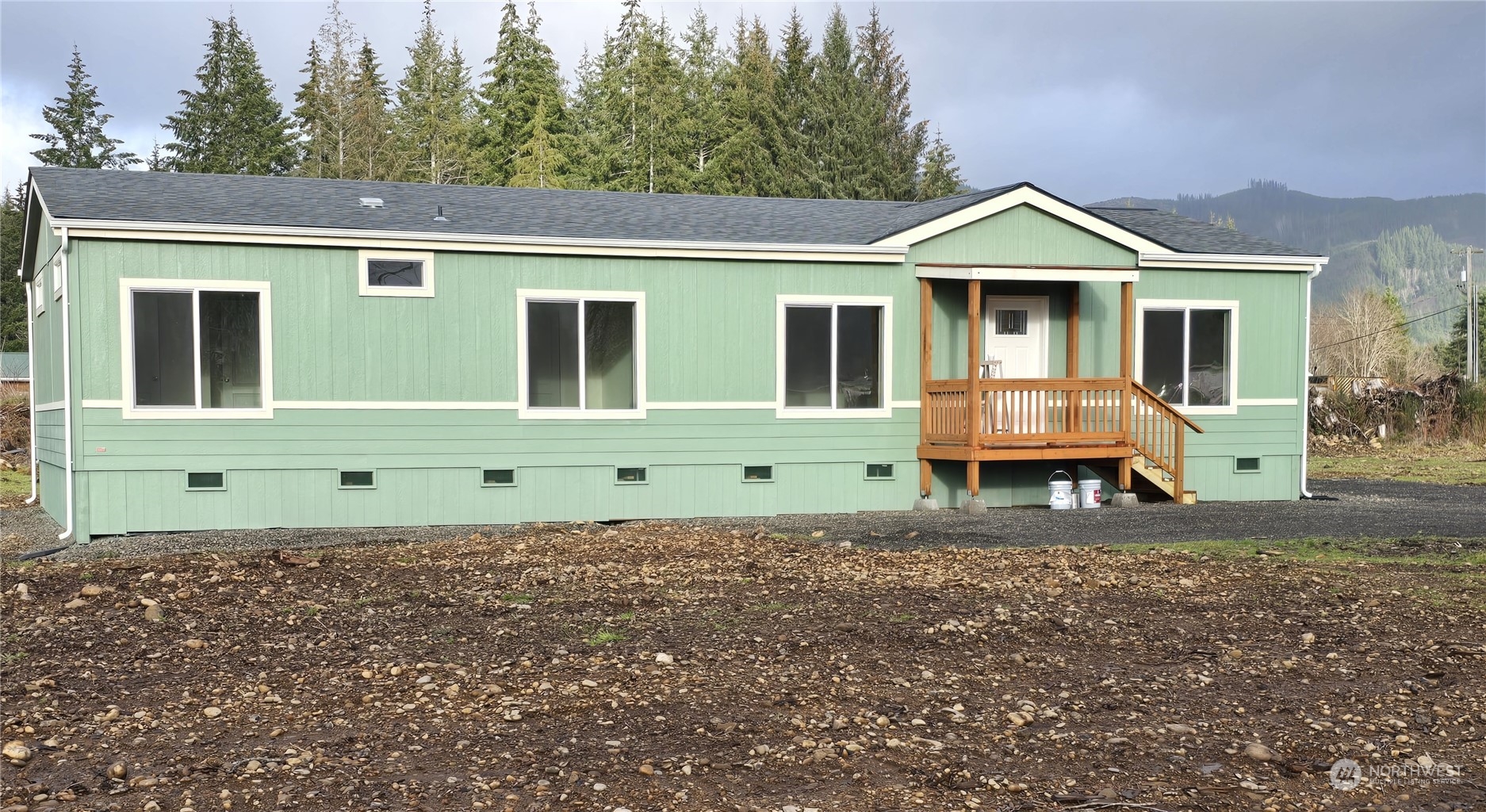 53 Newton Rd Forks Forks, WA 98331 - Photo 22 of 25 a front view of a house with a yard