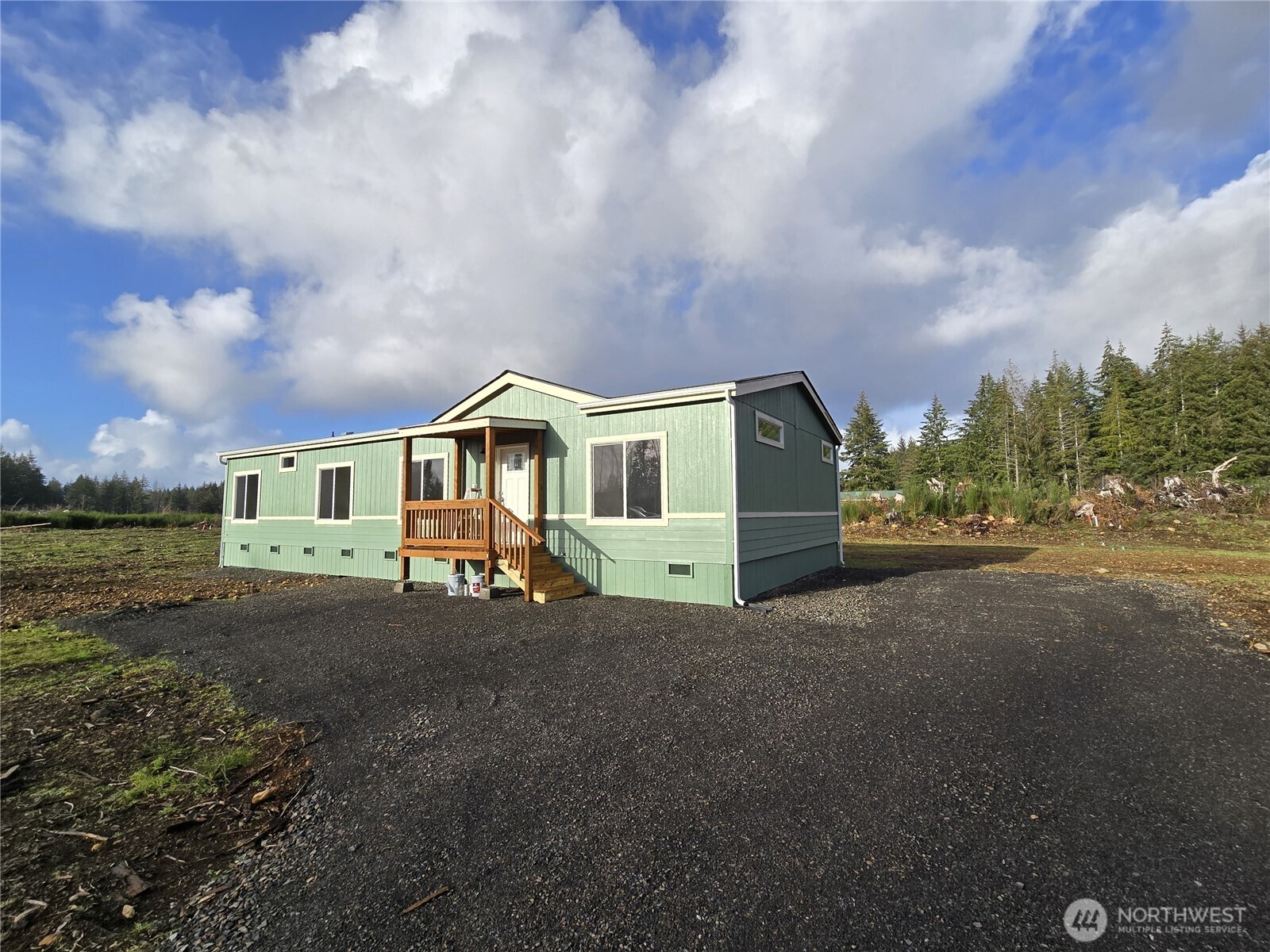 53 Newton Rd Forks Forks, WA 98331 - Photo 23 of 25 a front view of a house with a yard