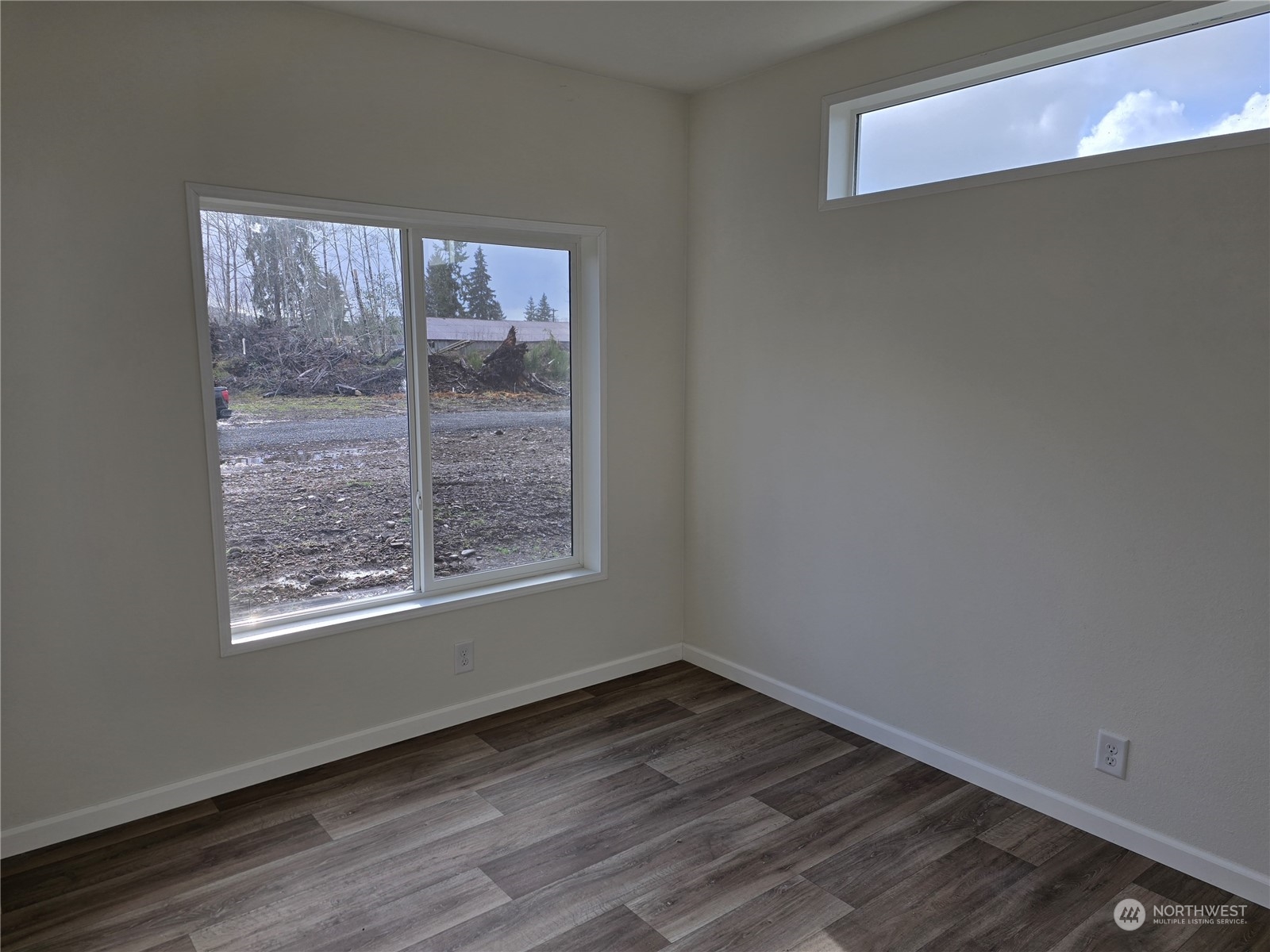 53 Newton Rd Forks Forks, WA 98331 - Photo 10 of 25 a view of an empty room with wooden floor and a window
