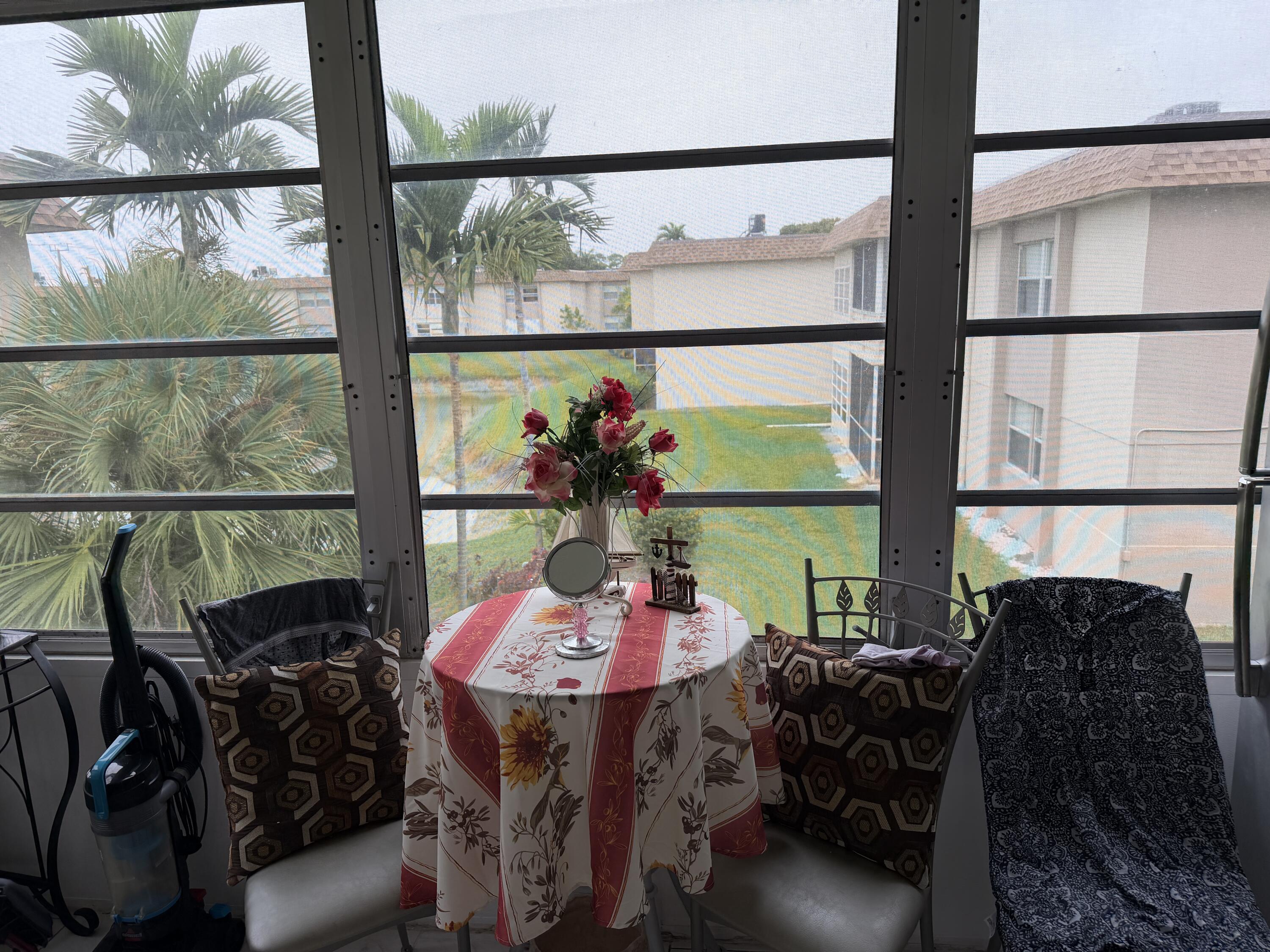 502 Davis Road, Unit 6 Palm Springs, FL 33461 - Photo 13 of 45 a view of a dining room with furniture window and outside view