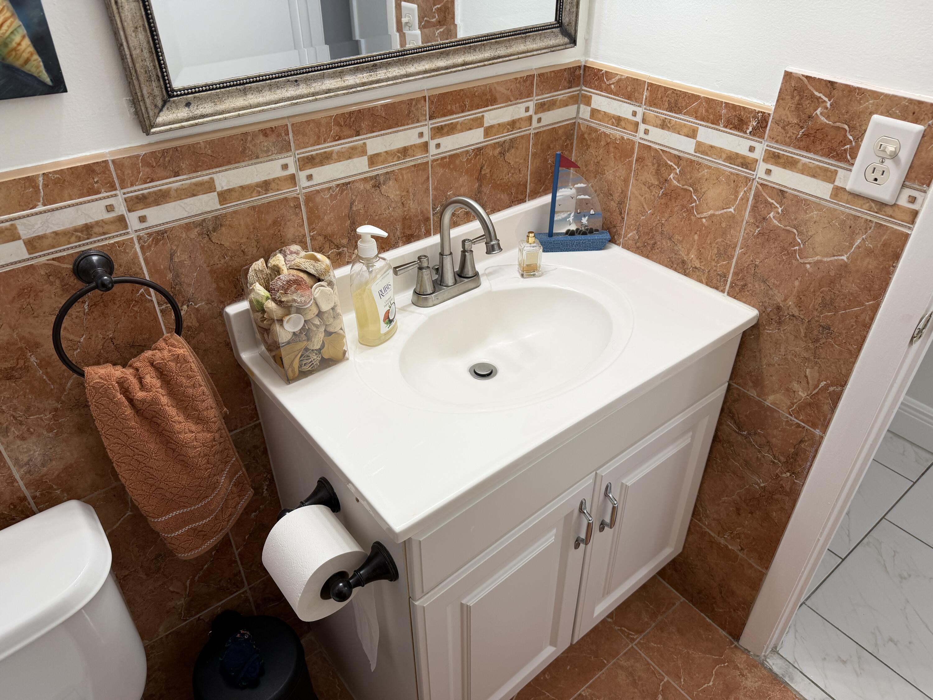 502 Davis Road, Unit 6 Palm Springs, FL 33461 - Photo 20 of 45 a bathroom with a sink mirror vanity and toilet