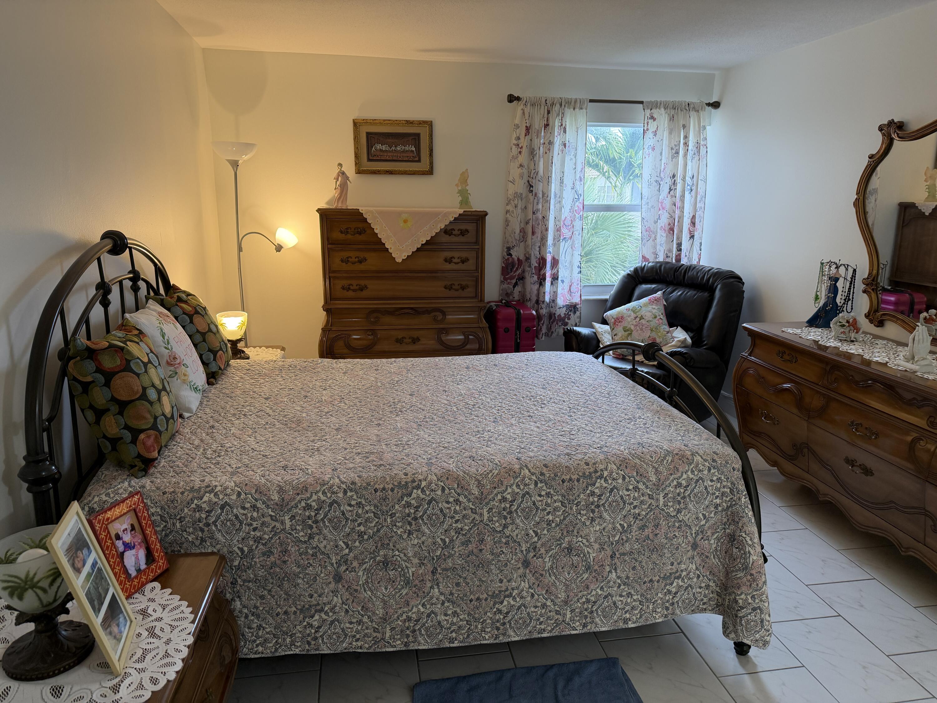 502 Davis Road, Unit 6 Palm Springs, FL 33461 - Photo 25 of 45 a bed sitting in a bedroom next to a window