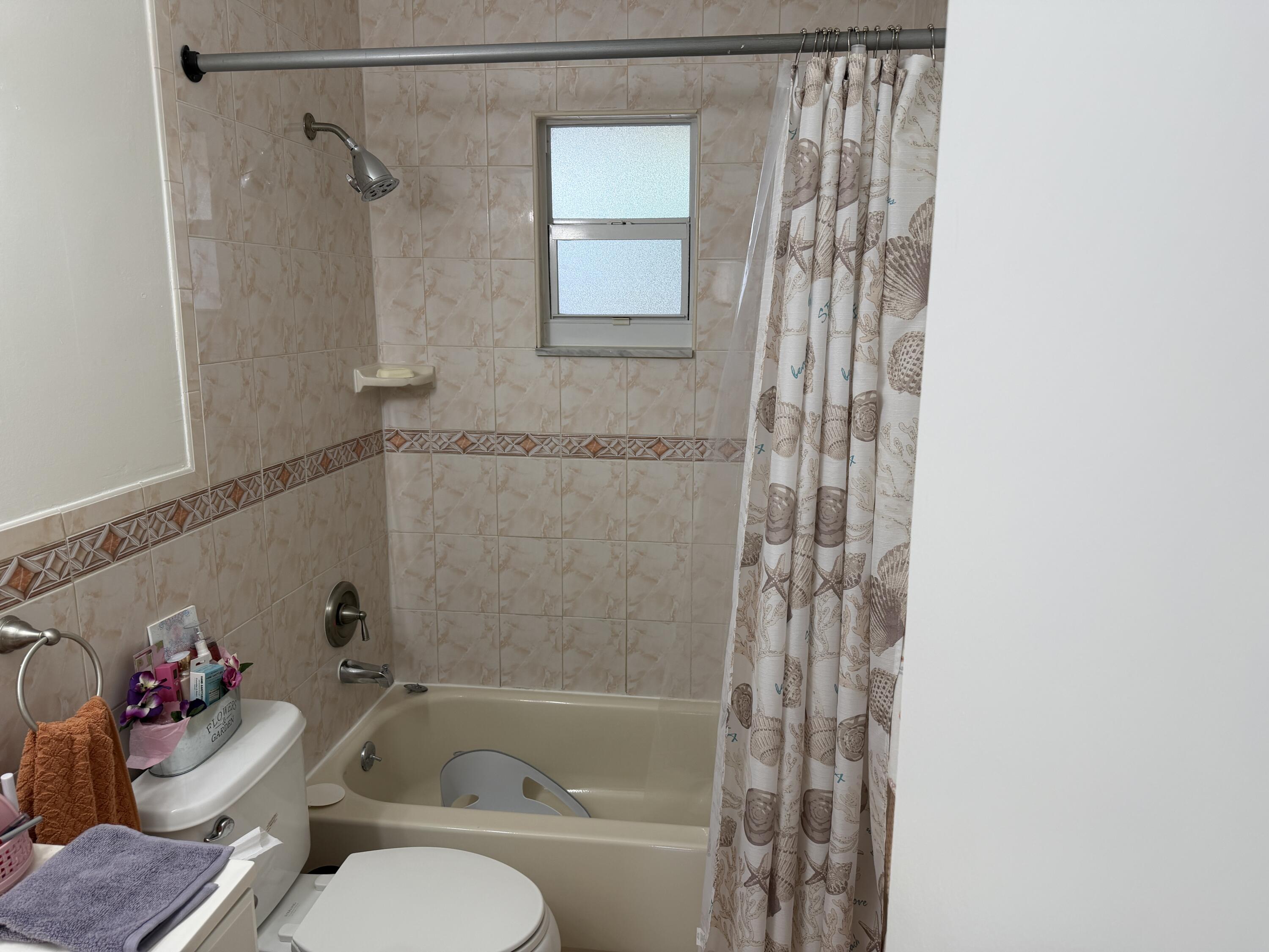 502 Davis Road, Unit 6 Palm Springs, FL 33461 - Photo 27 of 45 a bathroom with a bathtub and shower