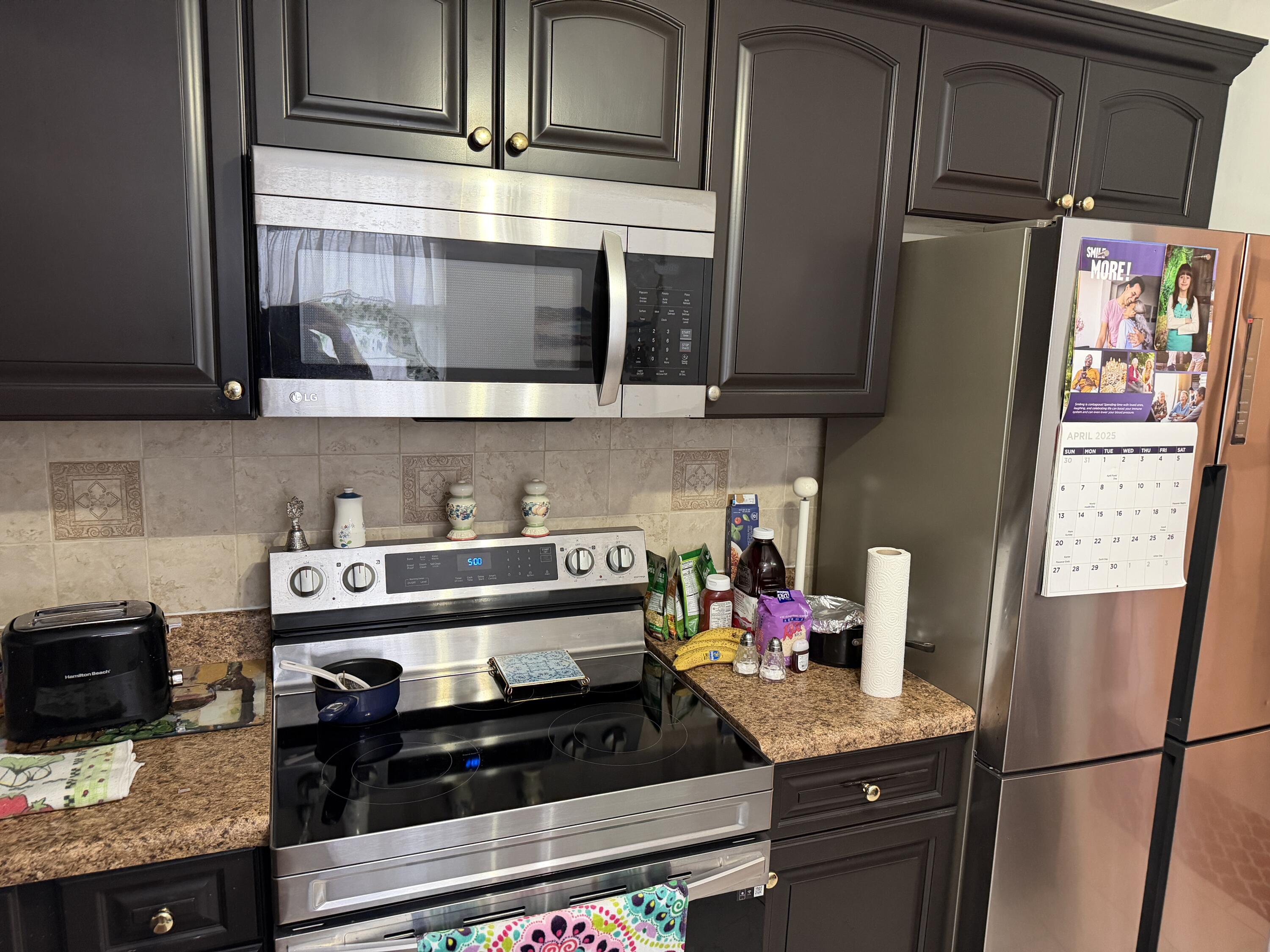 502 Davis Road, Unit 6 Palm Springs, FL 33461 - Photo 6 of 45 a kitchen with stainless steel appliances granite countertop a refrigerator stove and sink