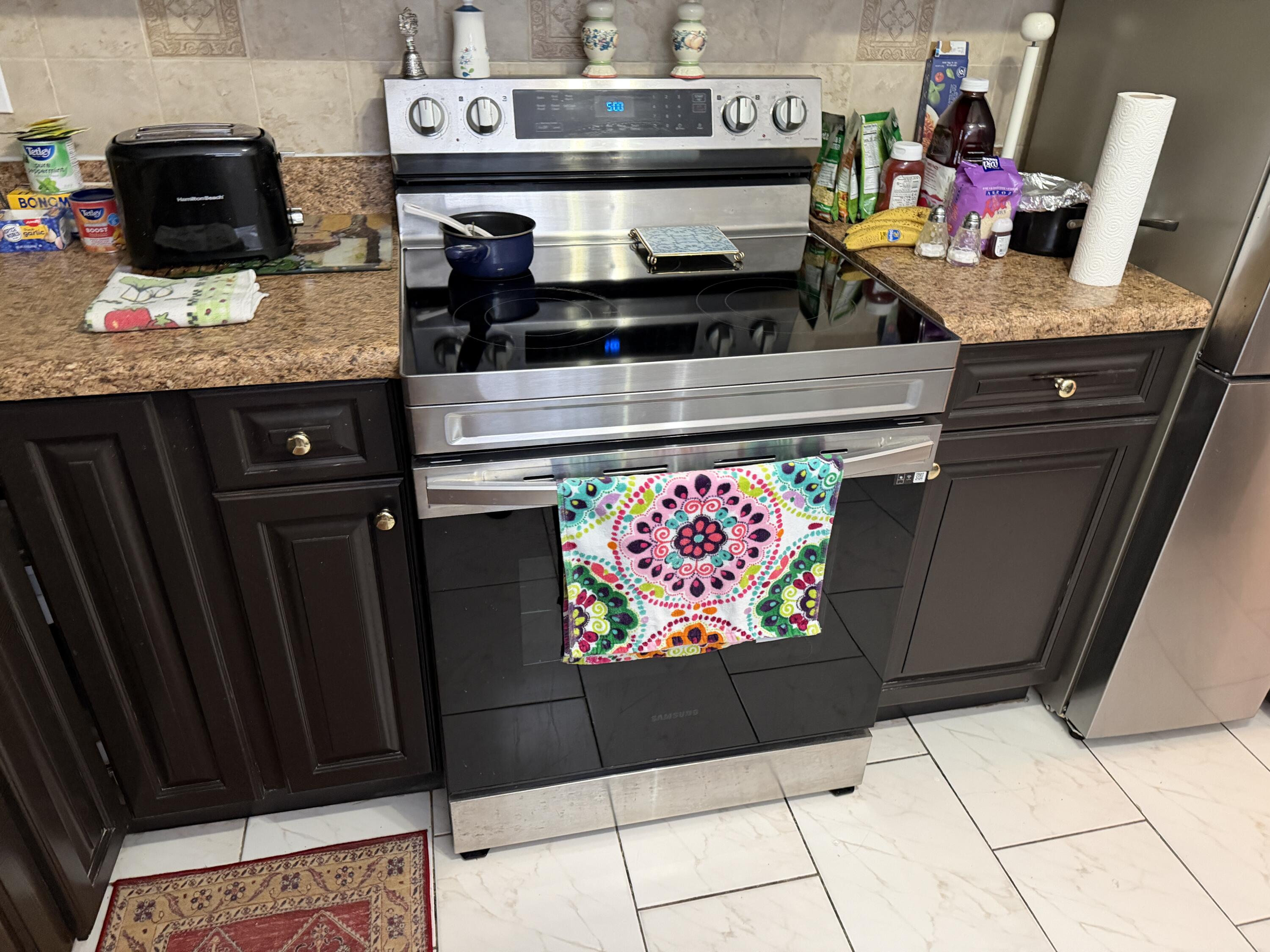 502 Davis Road, Unit 6 Palm Springs, FL 33461 - Photo 8 of 45 a kitchen with stainless steel appliances granite countertop a stove and cabinets