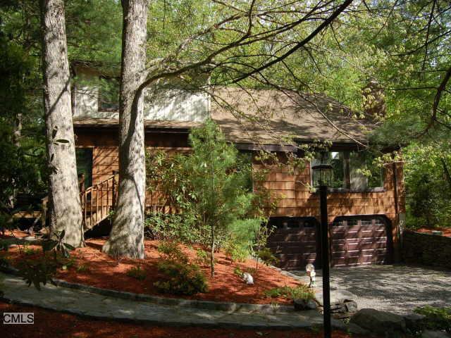 1555 Riverbank Road Stamford, CT 06903 - Photo 1 of 1 a backyard of a house with lots of green space