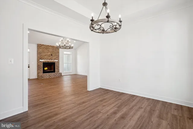 a view of a kitchen with a fireplace wooden floor and a kitchen