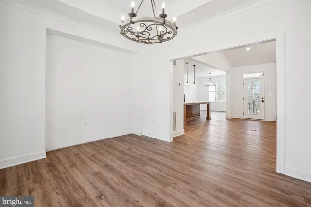 a kitchen with kitchen island a counter space a sink appliances and cabinets
