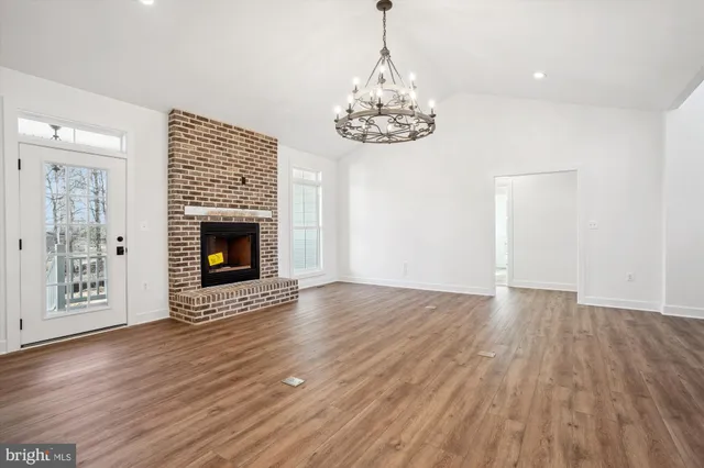 a large kitchen with stainless steel appliances granite countertop a stove a sink and a refrigerator