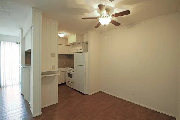 a view of a kitchen with a sink a refrigerator and a chandelier fan