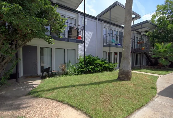 a view of a house with swimming pool and next to a yard