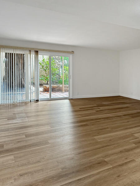 5740 Encina Road, Unit 3 Goleta, CA 93117 - Photo 4 of 29 a view of an empty room with wooden floor and a window