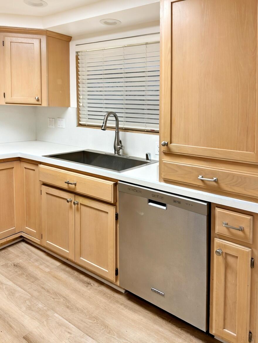5740 Encina Road, Unit 3 Goleta, CA 93117 - Photo 8 of 25 a kitchen with stainless steel appliances white cabinets and a window
