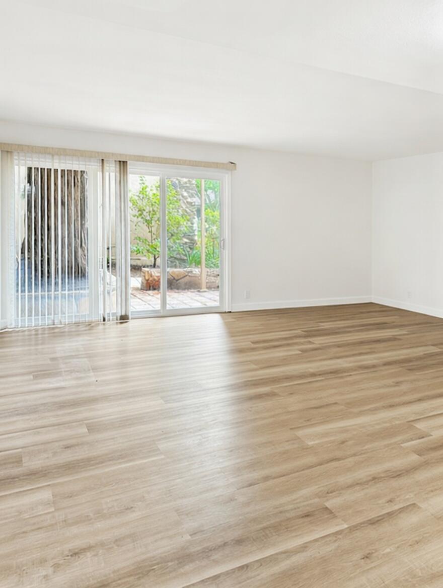 5740 Encina Road, Unit 3 Goleta, CA 93117 - Photo 9 of 25 a view of an empty room with wooden floor and a window