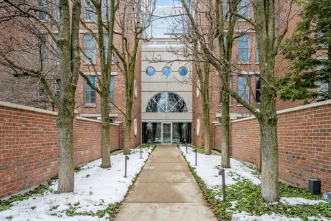 a view of a building with a tree in front
