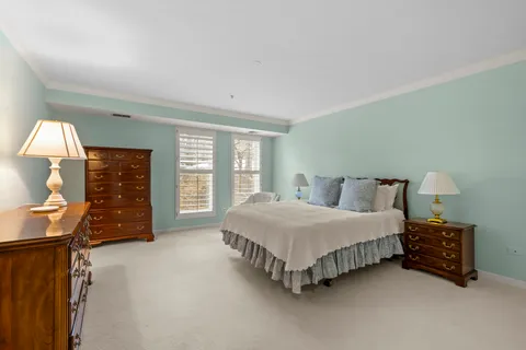 a spacious bedroom with a bed and a window