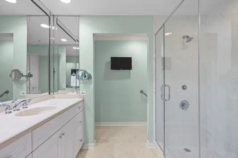 a bathroom with a shower sink and mirror