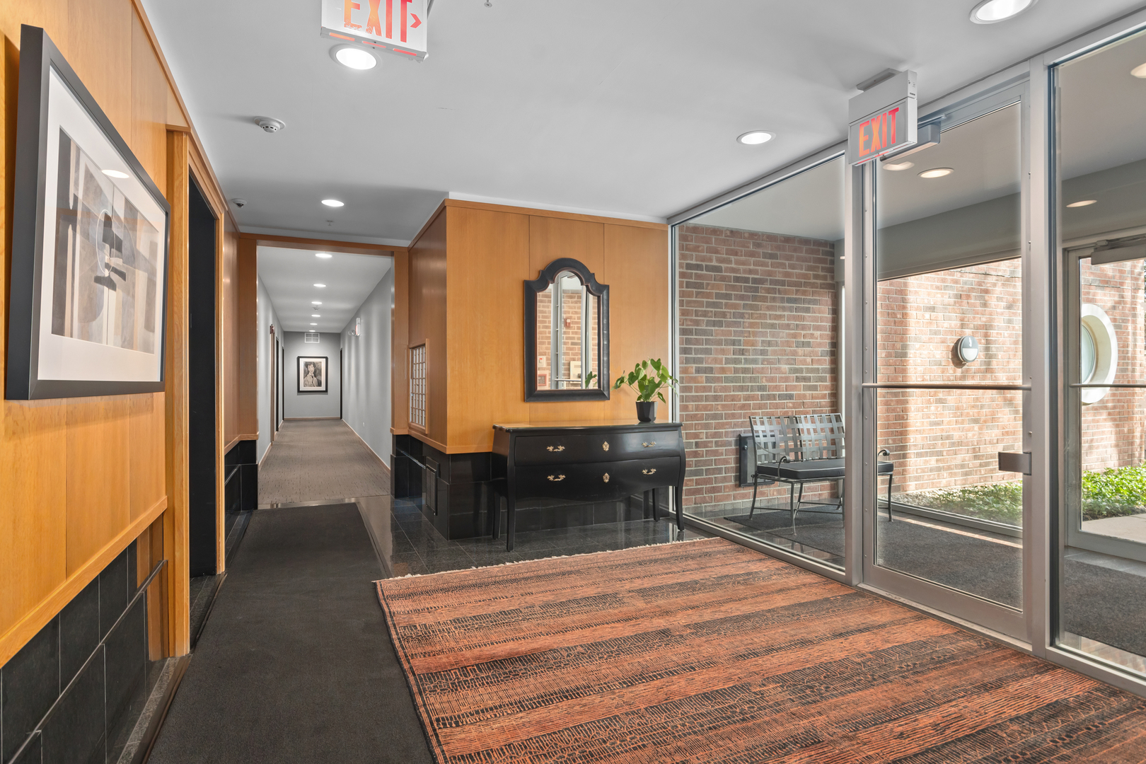 380 Green Bay Road, Unit 1B Winnetka, IL 60093 - Photo 2 of 19 a hallway with a large window dining table and chairs