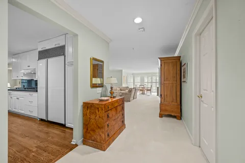 a living room with furniture and a kitchen view