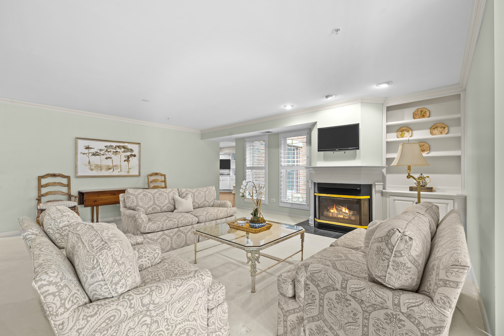 380 Green Bay Road, Unit 1B Winnetka, IL 60093 - Photo 7 of 19 a living room with furniture a fireplace and a flat screen tv