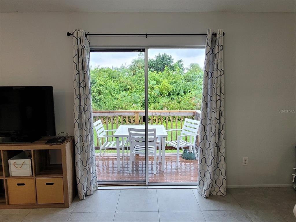 14447 Worthwhile Road Port Charlotte, FL 33953 - Photo 13 of 23 a living room with hardwood floor and a flat screen tv
