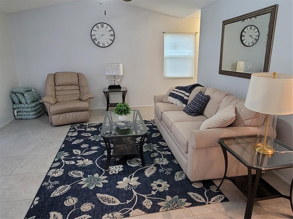 14447 Worthwhile Road Port Charlotte, FL 33953 - Photo 4 of 23 a living room with furniture and a rug