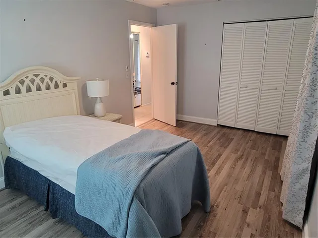 a spacious bedroom with a bed and a shower curtain